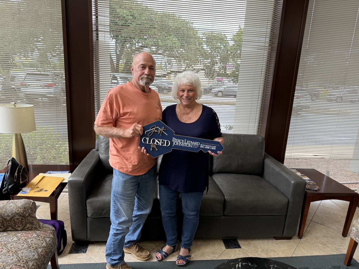 Tammy and Kenny holding a closed sign on closing day