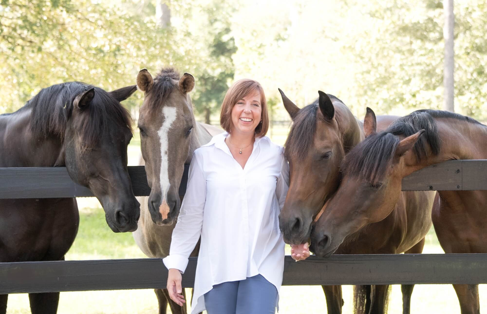 woman-with-horses-at-fence
