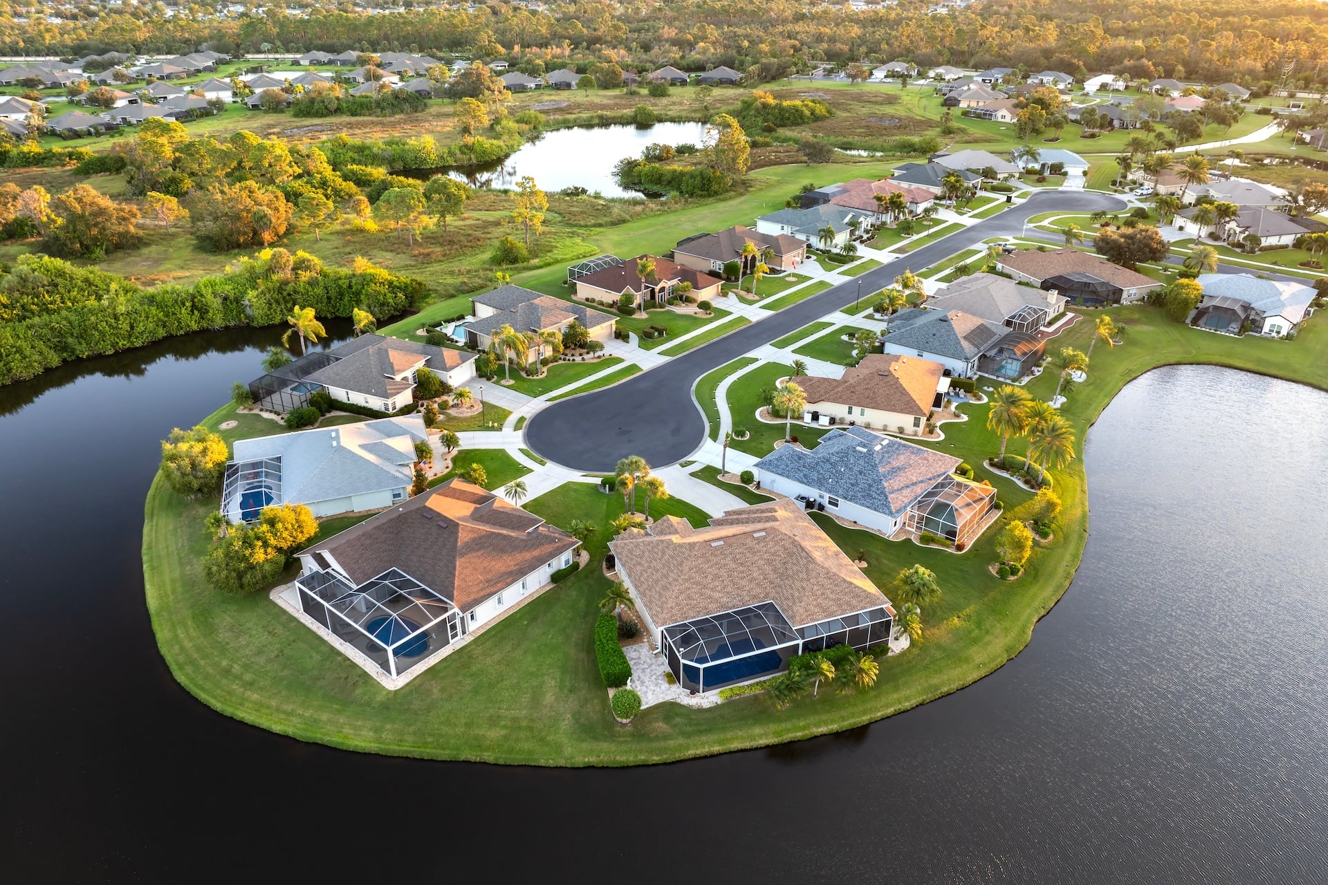 Low-density private homes at sunset. Rural street cul-de-sac dead end in residential suburbs with upscale suburban houses outside of Sarasota, Florida