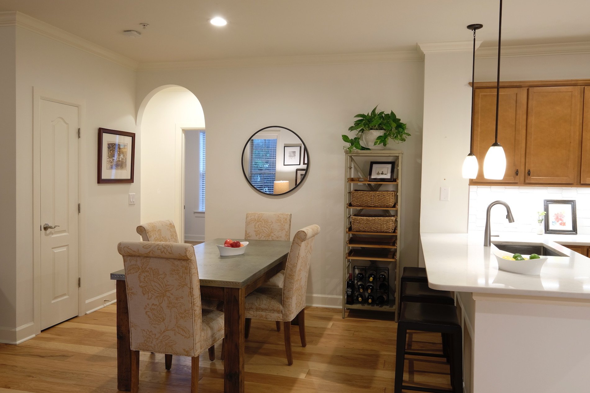 Sherwin Williams white paint, industrial dining table, house plant, white quartz counters