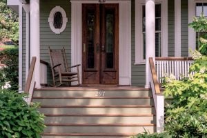 Beautiful front porch, white pillars, painted stairs, antique wood glass doors