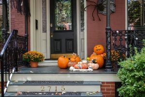 fall porch with pumpkins and spiders