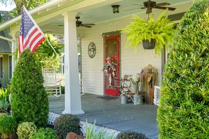 front porch with red door decorated for 4th of July