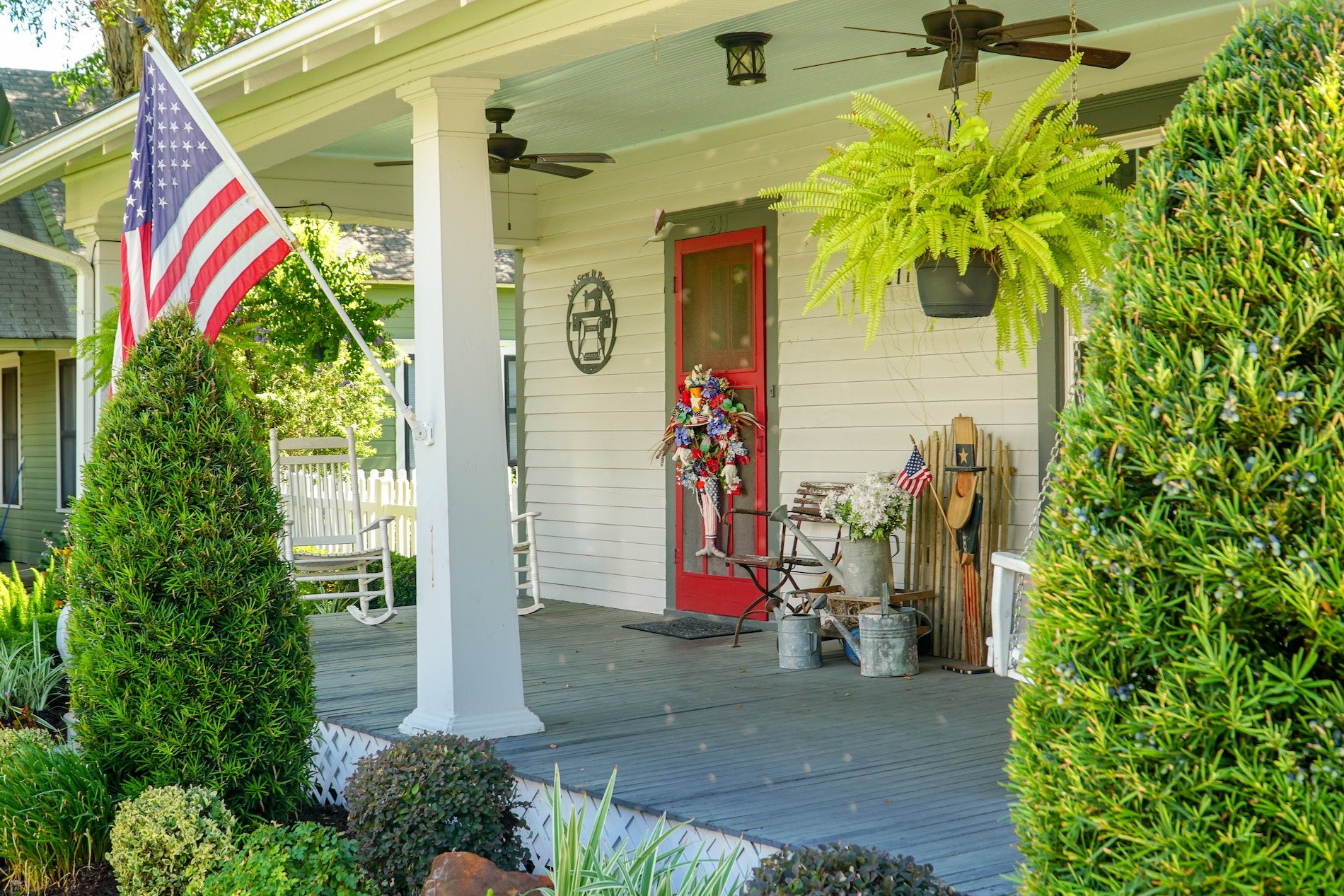 front porch with red door decorated for 4th of July